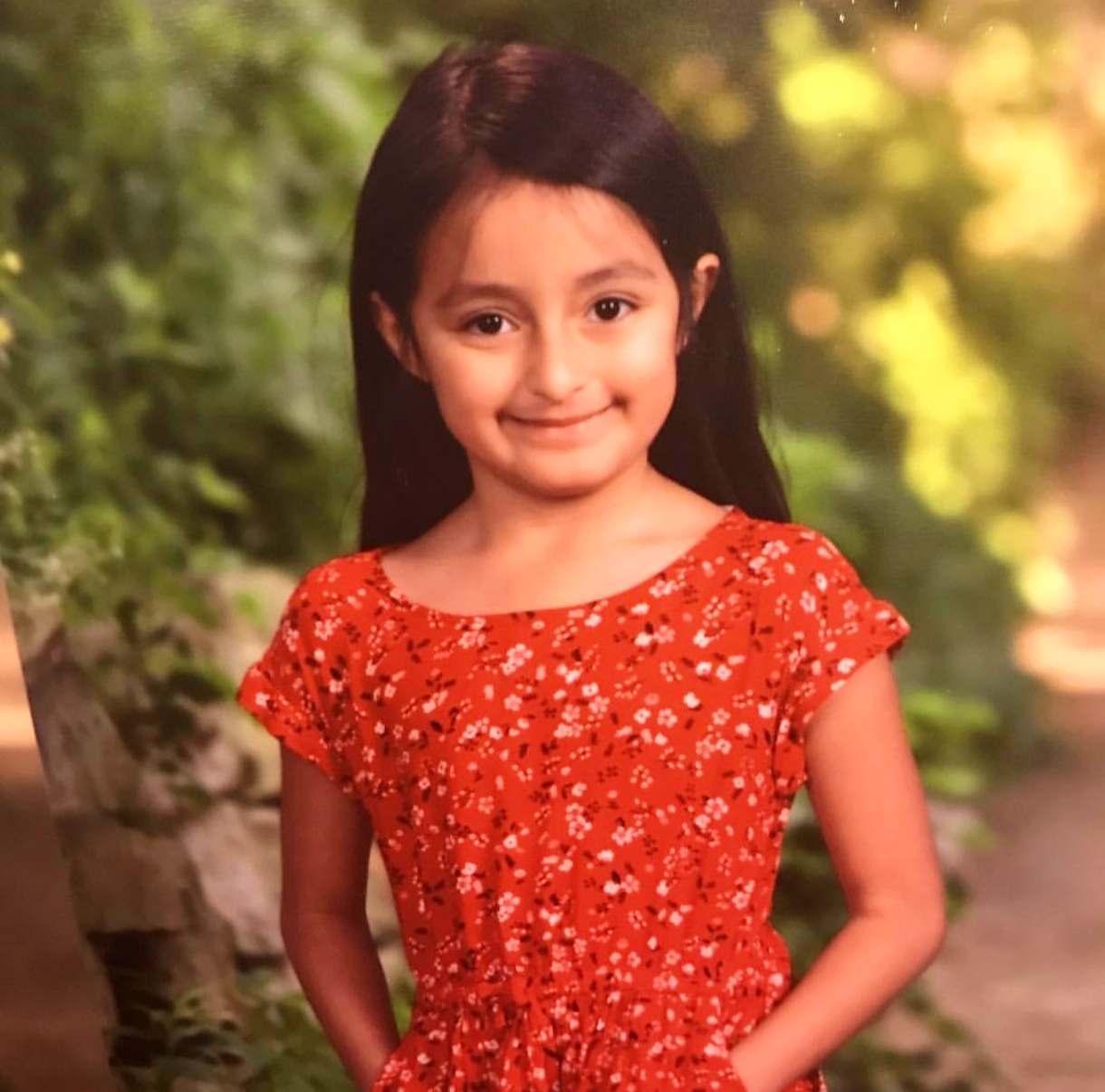 Childhood portrait of Yvanna in a red dress
